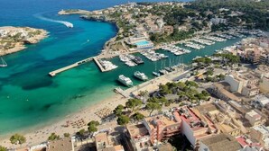 An aerial view of a coastal town with a marina, beach, and residential buildings. - Villa can Juanito- Paradise location, very close to the harbor, Porto Cristo beach (Porto Cristo)