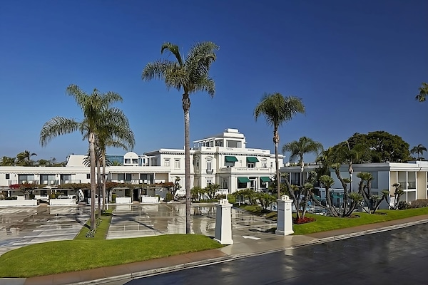 Arrive to a grand palm-lined exterior with resort-style charm.