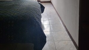 A room with a bed, a window, a sink, and a fan. - downtown montezuma hostal  (Montezuma)