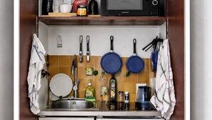 A compact kitchenette with a microwave, coffee maker, and a small refrigerator. - Parisian studio in the 17th district, fully equipped with balcony (Paris)