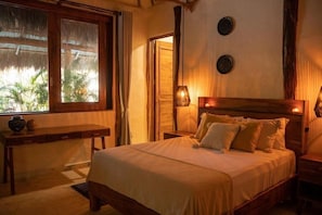A room with a bed, bedside table, and a window with curtains. - Kasa Uh May (Francisco Uh May)