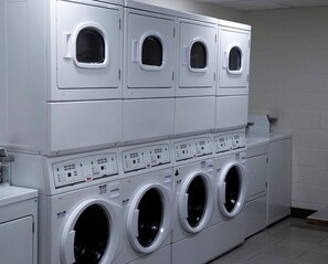 A laundry facility with multiple washing machines and dryers. - Accessible King Studio w/ Sofa Bed + Kitchen (Vaughan)