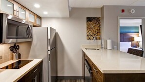 A compact kitchen with a microwave, refrigerator, and sink. - 1BR Queen Suite w/ Sofa Bed + Full Kitchen (Vaughan)
