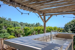An outdoor bar area with a pergola, string lights, and a view of a vineyard. - 🌅 Cavalaire | Infinite Sea View & Infinity Pool (Cavalaire-sur-Mer)