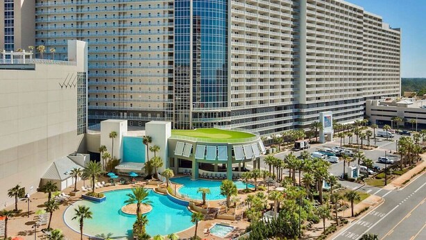 A hotel with a large pool area, multiple floors, and a modern architectural design. - Gulf View Resort Penthouse Condo! Beach & Pools (Panama City Beach)