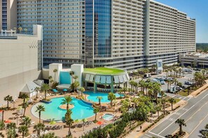 A hotel with a large pool area, multiple floors, and a modern architectural design. - Gulf View Resort Penthouse Condo! Beach & Pools (Panama City Beach)