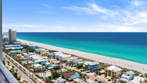 A coastal town with a beach, buildings, and a clear sky. - Gulf View Resort Penthouse Condo! Beach & Pools (Panama City Beach)
