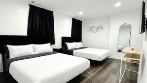 A hotel room with two beds, a small table, a mirror, and a wall-mounted artwork. - Modern Berwyn Retreat - 15 Min to Midway - Easy Access to Chicago (Berwyn)