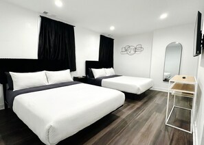 A hotel room with two beds, a small table, a mirror, and a wall-mounted artwork. - Modern Berwyn Retreat - 15 Min to Midway - Easy Access to Chicago (Berwyn)