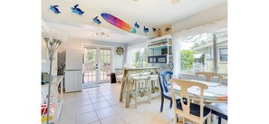 A kitchen with a dining area, a view of the outside, and a ceiling with decorative elements. - Gulf Gate Getaway (Sarasota)