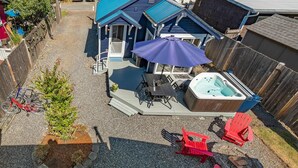A backyard with a hot tub, outdoor seating, and a small tree. - Boho Blue Heron, BBH 7532 (Birch Bay)