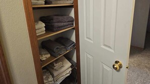 A closet with shelves containing folded clothes. - Spacious Family Home w Garage  Gladys Retreat (Hermiston)