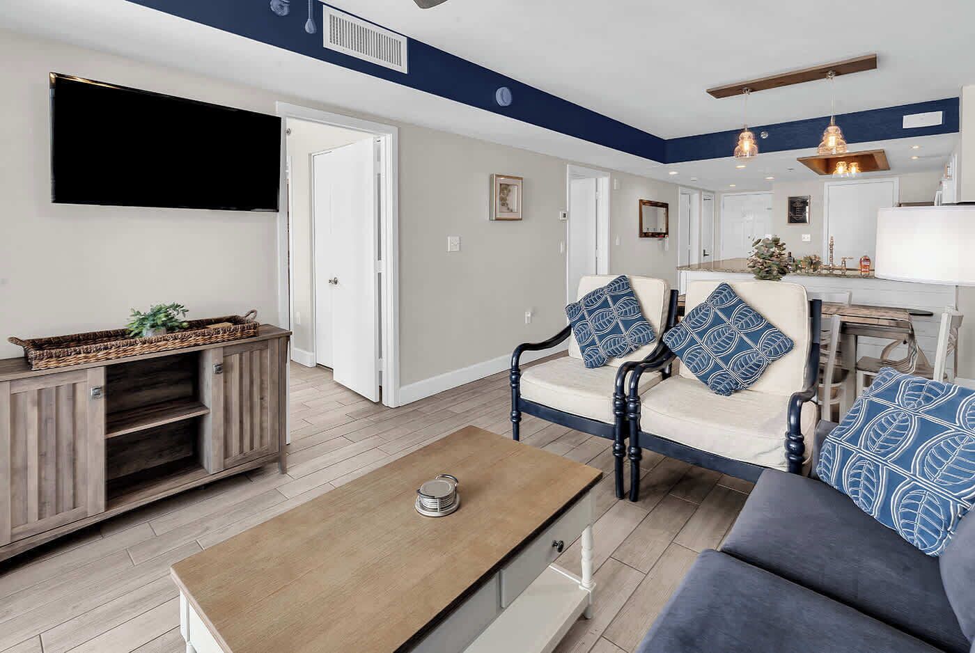 A living room with a sofa, a coffee table, a TV, and a cabinet.
