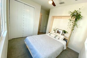 A bedroom with a bed, a closet, a ceiling fan, and a potted plant. - Furnished Townhome with Sauna, Cold Plunge, and Hot tub. Short-term available (St. Petersburg)