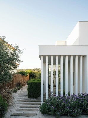 A modern building with a pathway leading to a glass door entrance. - Modern Elegance Meets the Wild Beauty of Carvalhal (Carvalhal)