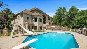 A two-story house with a swimming pool, a slide, and outdoor furniture. - LL Unit w/ Private Access in Luxurious Riverfront Vacation Home (Oak Grove)