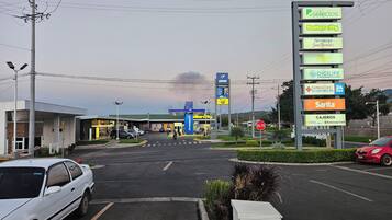 A commercial area with a gas station, a pharmacy, and a supermarket.
