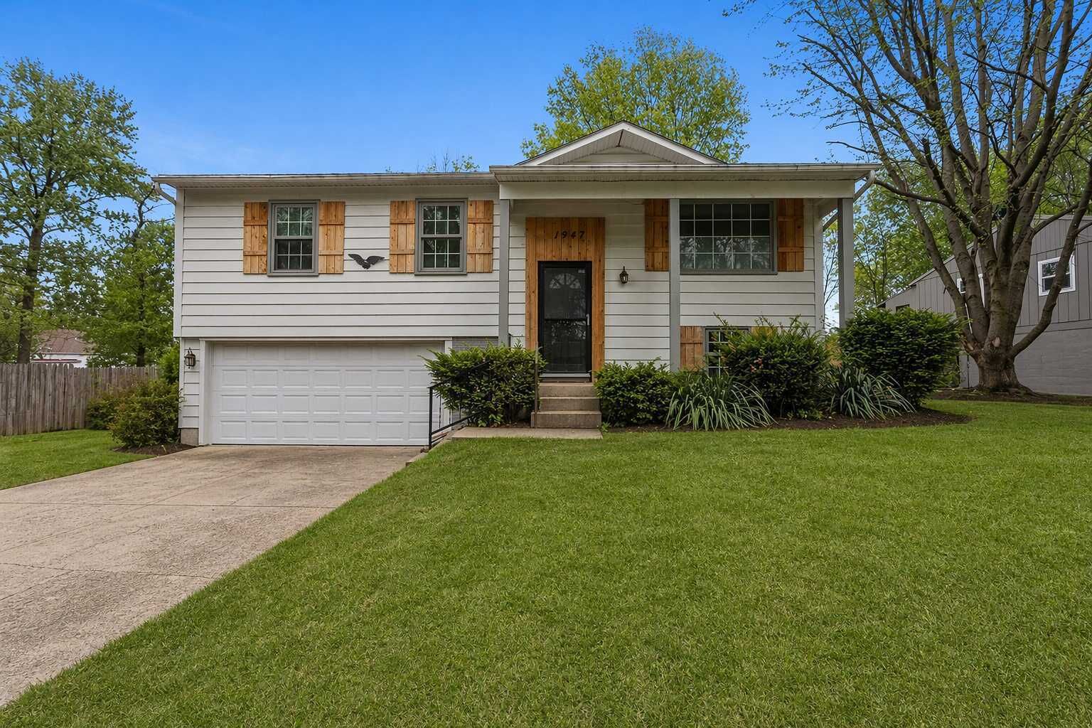 A single-story house with a front garage, a front porch, and a small front yard.