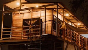 A multi-level wooden structure with balconies and staircases. - CABAÑA CASA BLANCA HUACACHINA PERU ACCOMMODATION & TOURS (Huacachina)