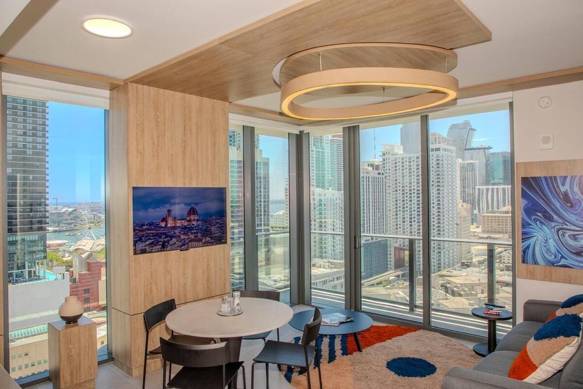 A modern room with a city view, a round table, and a sofa.