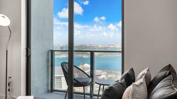 Apartment, Balcony, City View | Living area | 50-inch Smart TV with cable channels