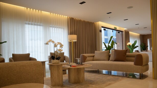 A modern living room with a sofa, armchairs, a coffee table, and a lamp. - Seven Luz Serviced Apartments – Al Masif Branch (Riyadh)