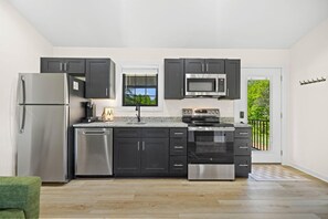 Fridge, microwave, oven, stovetop - Red Wolf Cabin | 2 Queen Suites, Hot Tub, Wi-Fi, & Easy Access in Rogers, KY (Rogers)