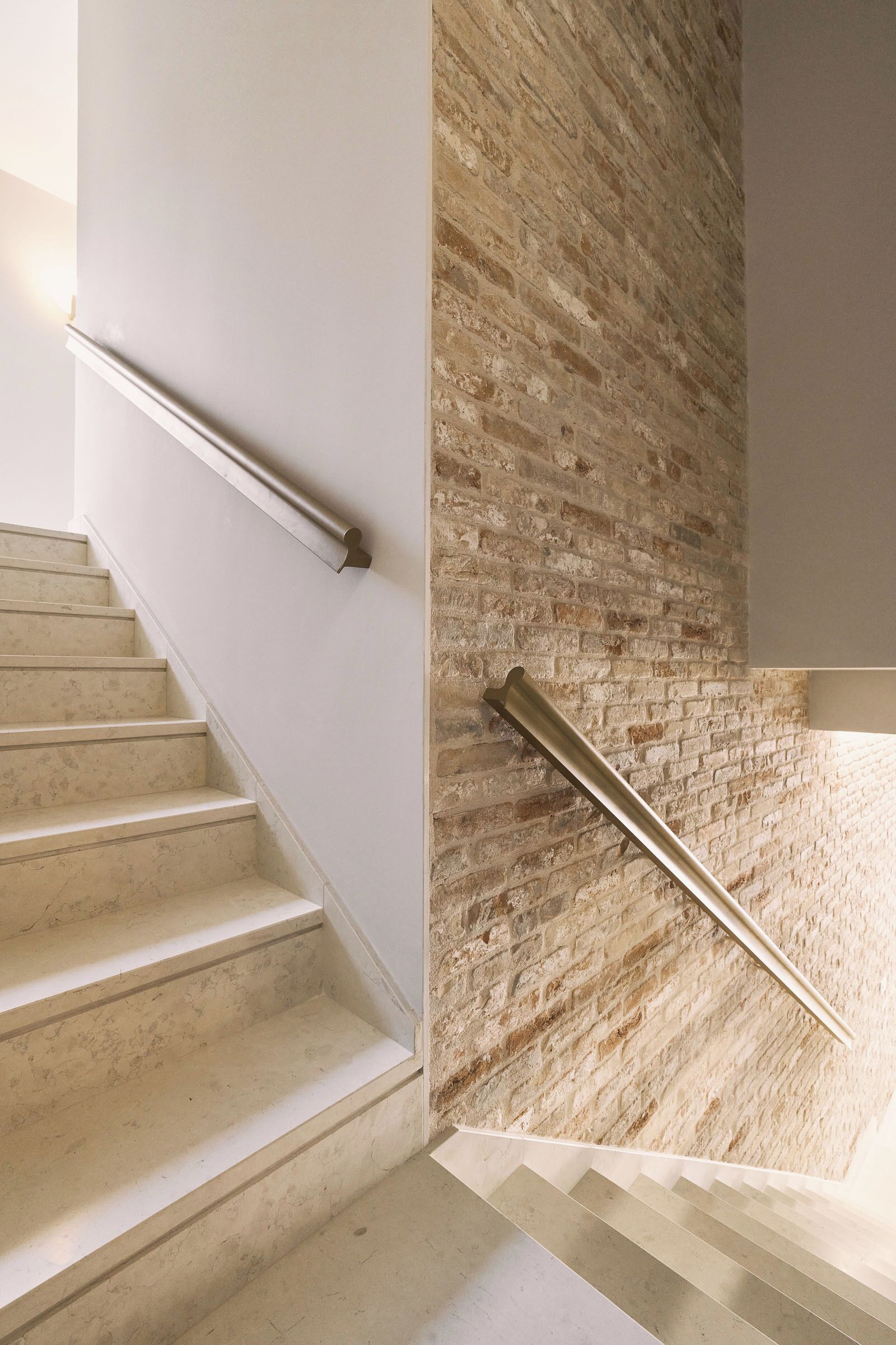 A staircase with a modern design, featuring a combination of plain and textured walls.