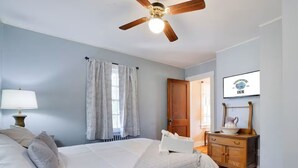 A bedroom with a bed, a wooden dresser, a ceiling fan, and a framed picture on the wall. - Narrowsburg Inn Vacations (Narrowsburg)