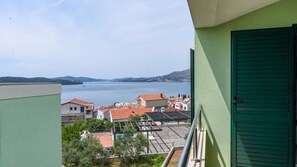 Ein Balkon mit Blick auf einen See und umliegende Gebäude.