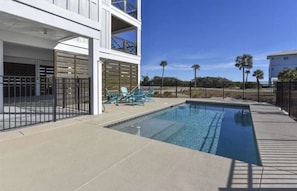 A swimming pool with a clear blue water, surrounded by a paved deck. - Rising Sun Pool Elevator  Pet Beach Access (Eastpoint)