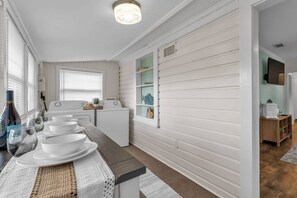 A kitchen with a central island, a built-in oven, and a window with blinds. - Lakeland Group Retreat | Sleeps 18 Across 3 Private Units | Walk to Lakes & Florida Southern (Lakeland)
