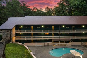 A multi-story building with a swimming pool, surrounded by trees. - Cozy w/King Bed and Game Room! 5 Min to Parkway (Gatlinburg)