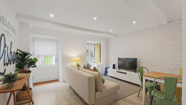 A modern living room with a sofa, TV, and dining area. - Newly Furnished! 1BR/1BA in OldLisbon SaoBento (Lisboa)