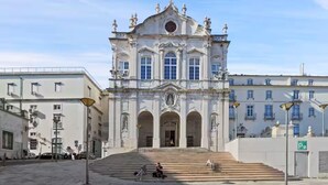 A grand building with a central entrance, steps leading up to it, and a cross at the top. - Newly Furnished! 1BR/1BA in OldLisbon SaoBento (Lisboa)