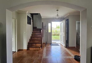 A staircase leading to a landing with a view of a garden.