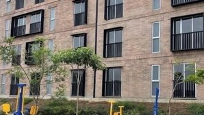 A multi-story building with a brick facade, multiple balconies, and a flat roof. - Ideal apartment for families, barbecue, court and children's play areas. (Oaxaca de Juárez)