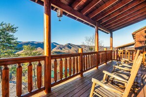 A wooden deck with a railing overlooking a mountainous landscape. - Beaver's Mountaintop Retreat! Pool Cabin | Top 5% (Pigeon Forge)