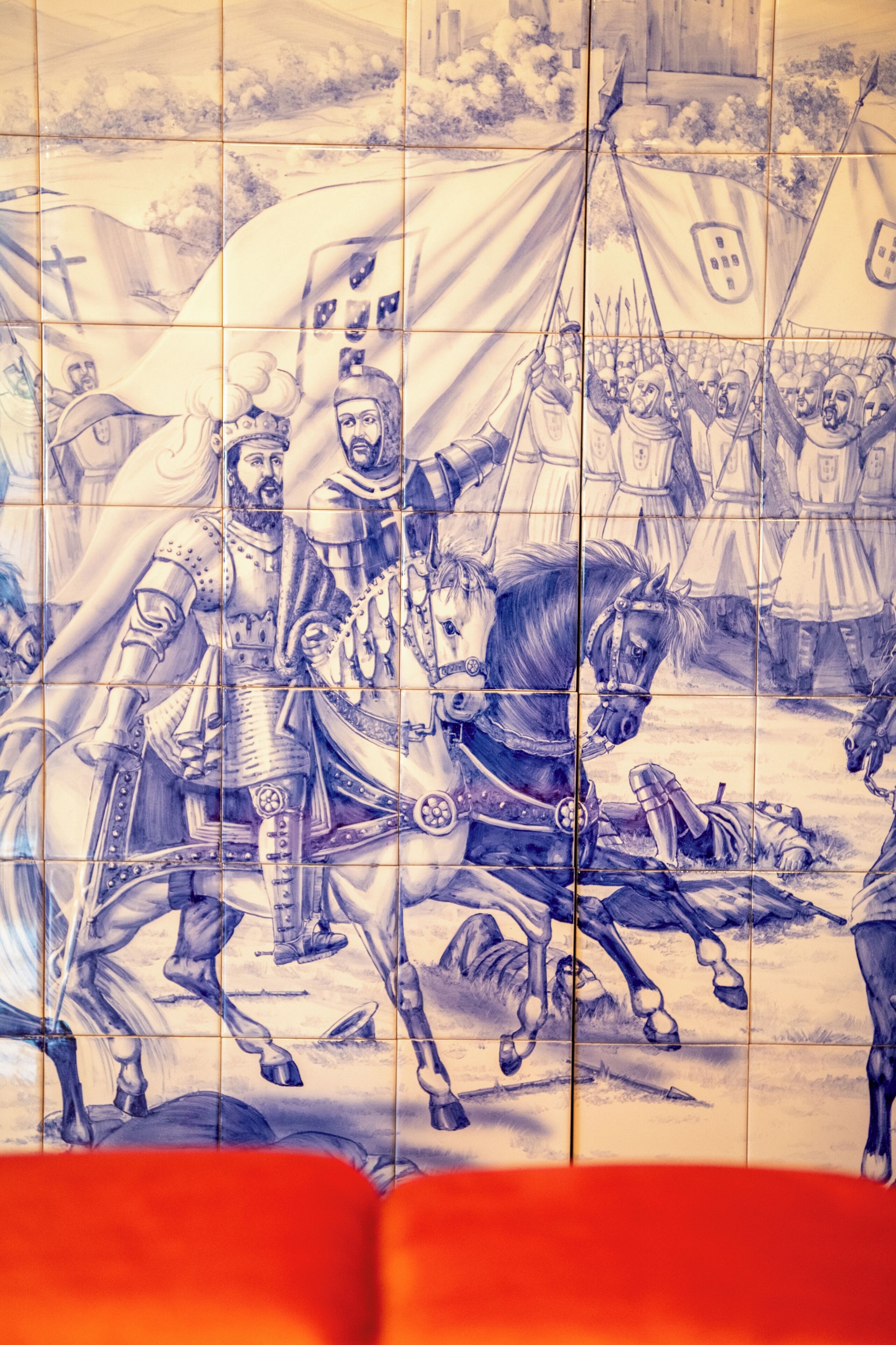A tiled wall with a historical battle scene.