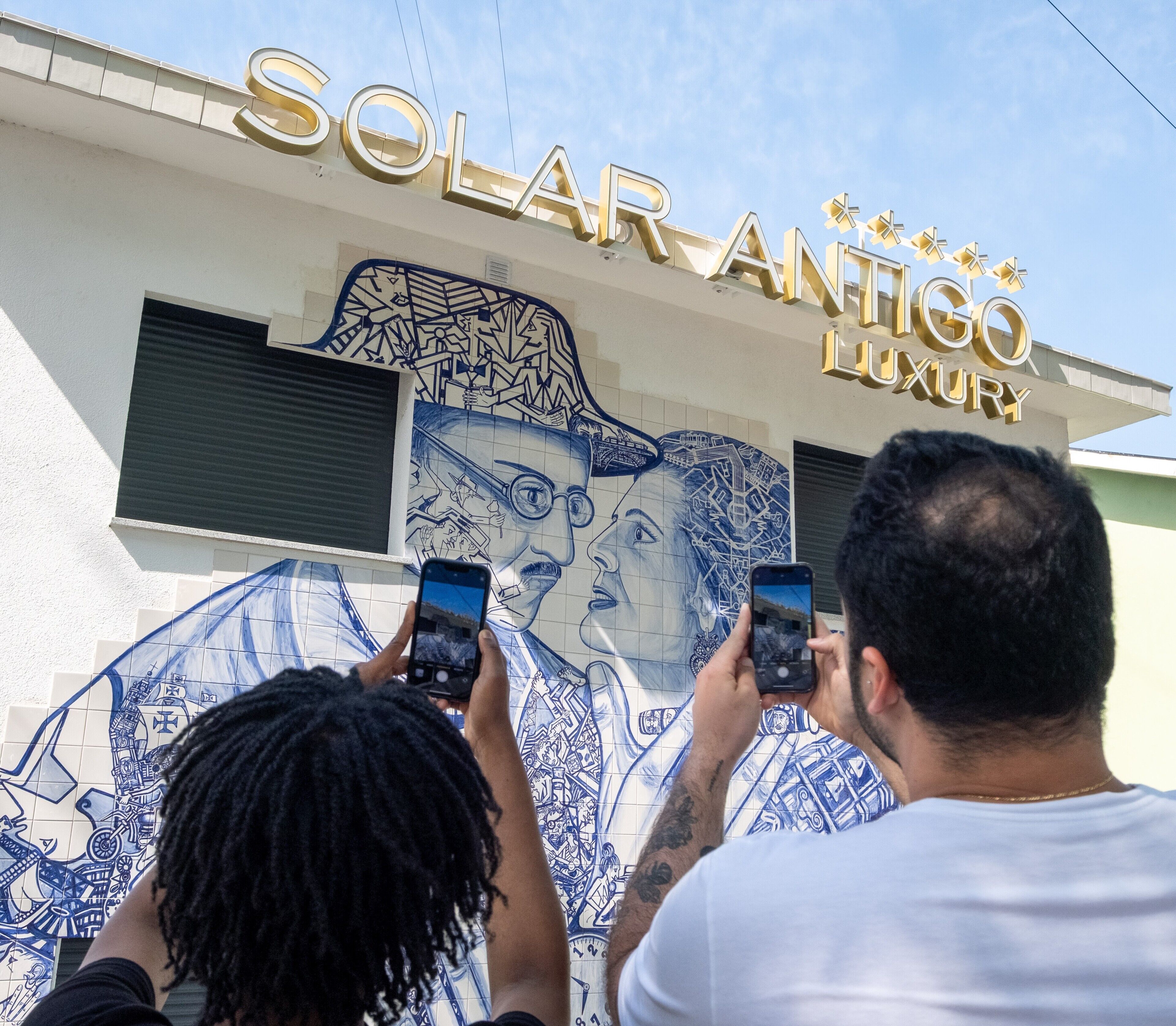 A building with a sign reading 'SOLAR ANTICO LUXURY' and a mural with a face.