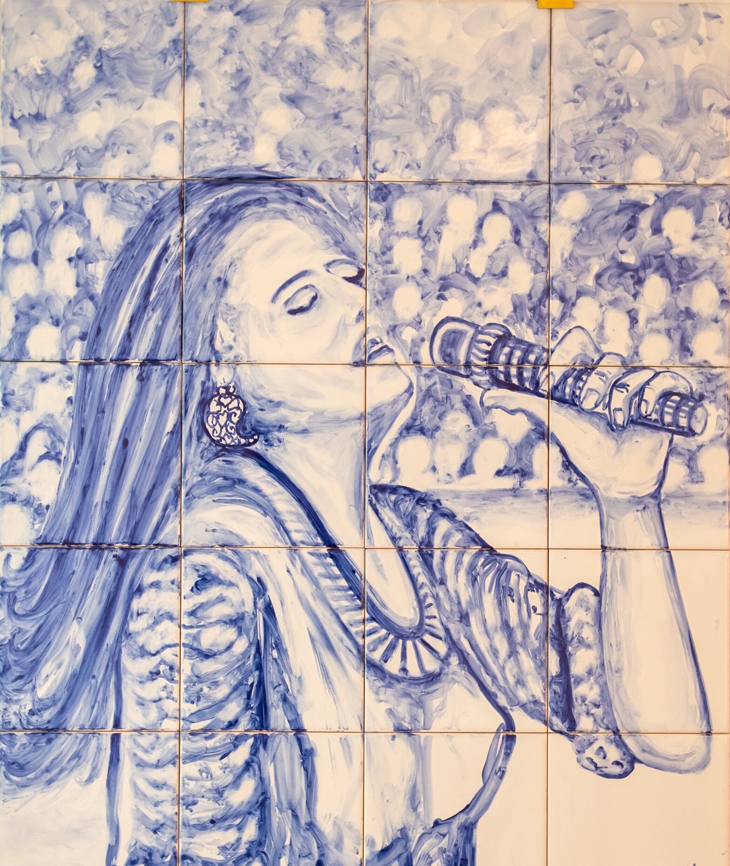 A tiled wall with a blue and white abstract pattern.