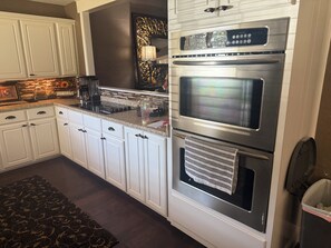A kitchen with white cabinets, a stainless steel range, and a built-in oven. - Delightful 4-bedroom house with AC in lively Lubbock (Lubbock)
