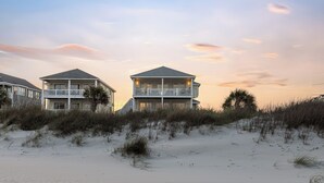 A beachfront property with multiple buildings, including a two-story house with a balcony and a larger house with a roof terrace. - aOceanfront | Incredible Views | Steps to the Beach (Surf City)