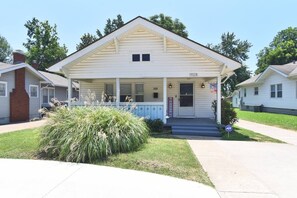 A single-story house with a porch, a small front yard, and a mailbox. - NEW- LUXURY CHERRY ST -SHOP DINE -2 BEDROOM HOUSE-HOSPITALS-RT 66--DOWNTOWN (TULSA)