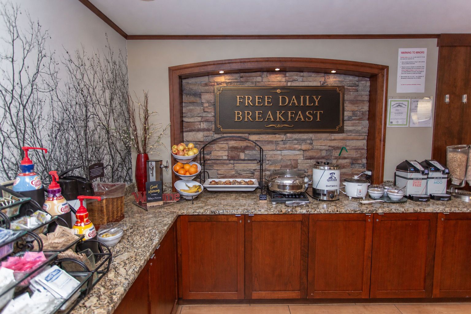 A breakfast area with a sign stating 'FREE DAILY BREAKFAST'.
