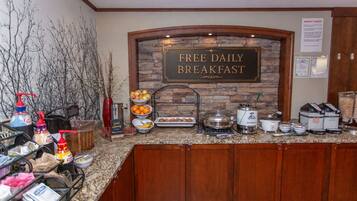 A breakfast area with a sign stating 'FREE DAILY BREAKFAST'.