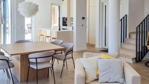 A modern living space with a dining area, a sofa, and a staircase. - Beautiful home in Makarska (Makarska)