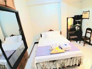 A hotel room with a bed, a desk, a chair, and a mirror. - AMA is 2 floor levels unit in a 4 storey building,3 BR, 2 Bath in Sevilla Norte (San Fernando City)