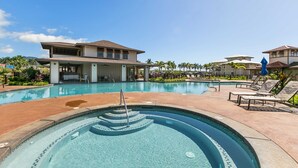 A swimming pool area with lounge chairs and a covered seating area. - Pili Mai 12K Spacious 3BR with Central AC (Koloa)