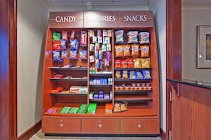A candy, sundries, and snacks display in a hotel lobby.